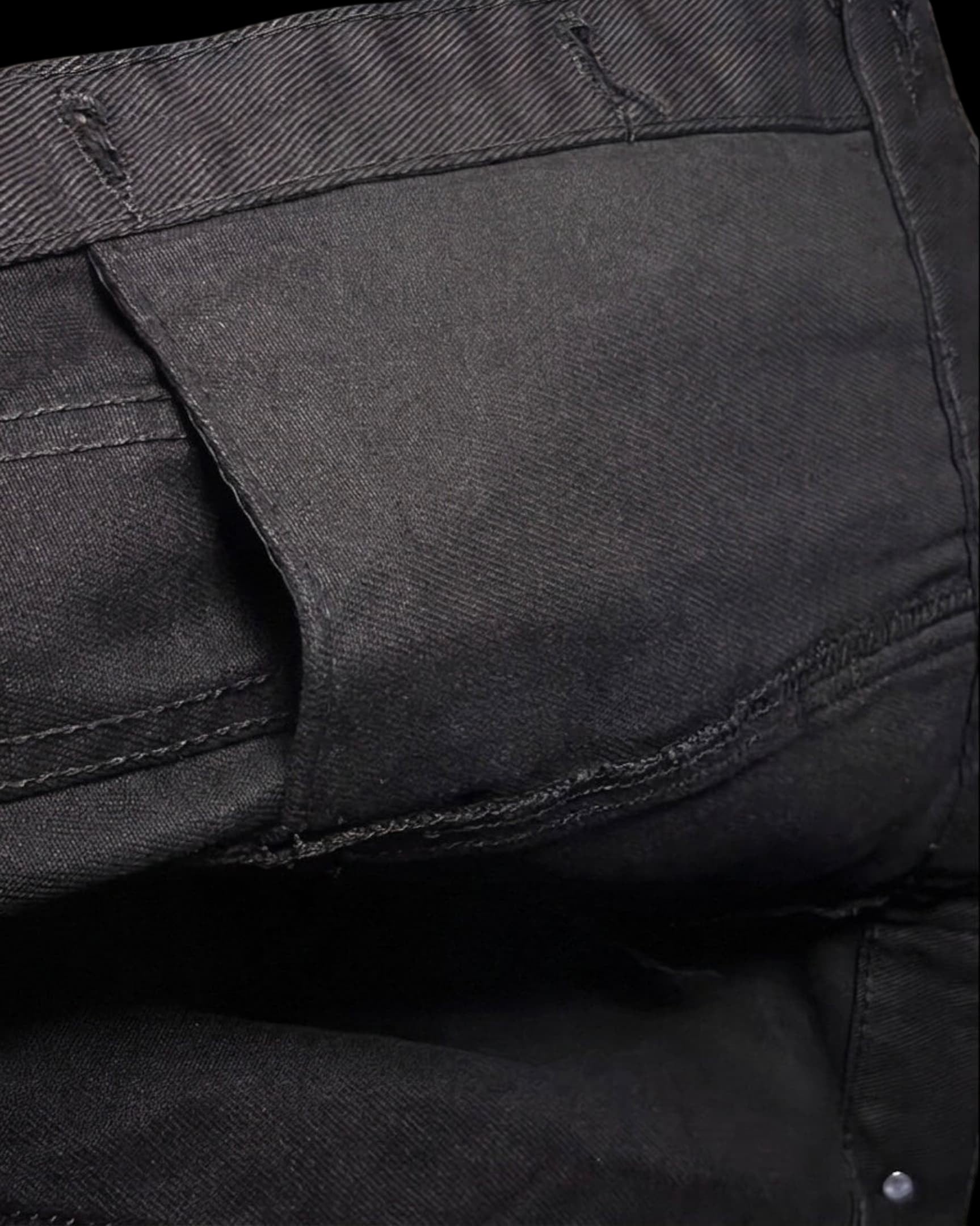 Close-up of a black Vicious slim fit denim jacket showing durable cotton blend fabric and reinforced stitching.