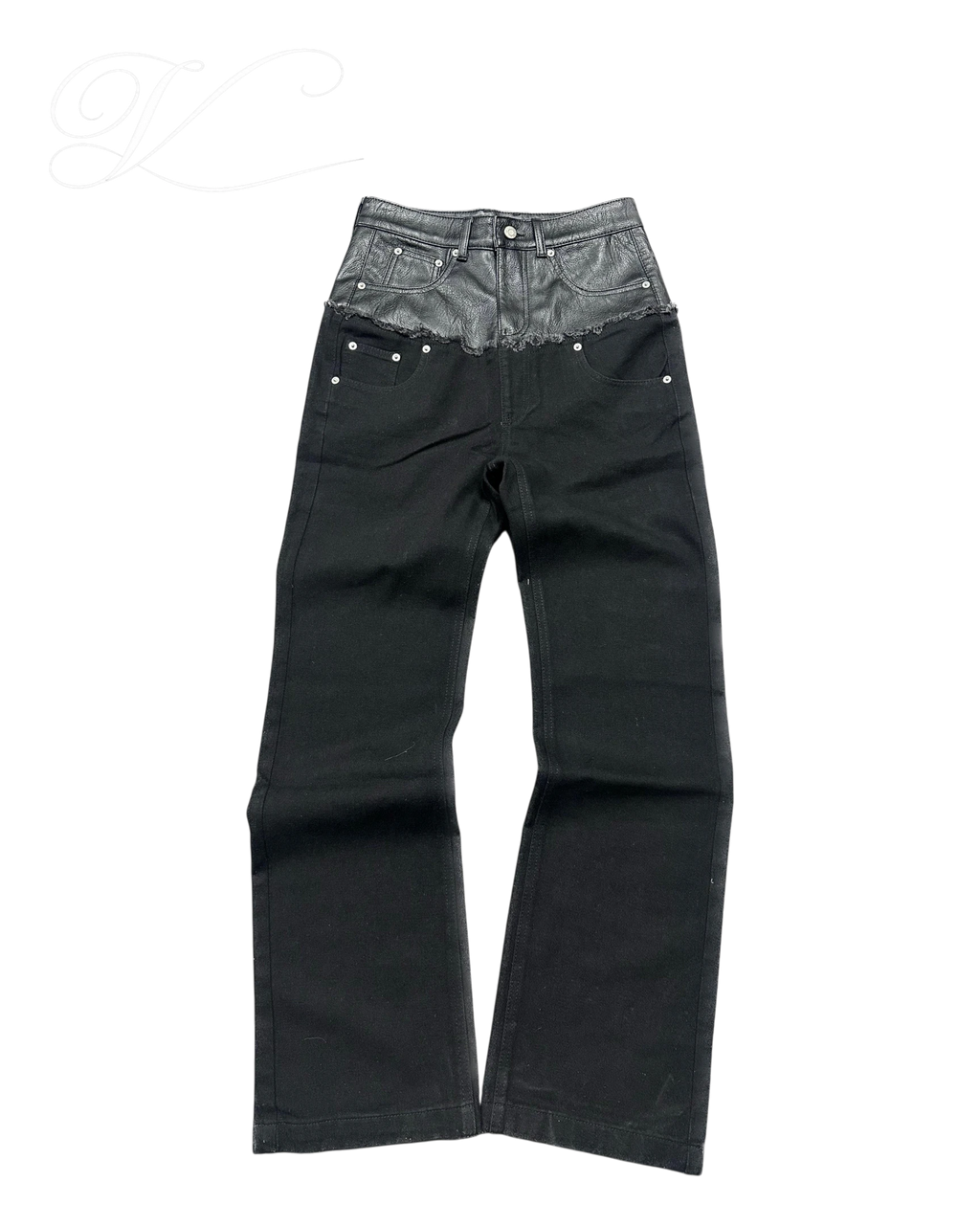 Vicious black denim jeans with a mid-rise waist featuring a contrasting faux leather panel and raw edge detail.