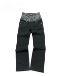 Vicious black denim jeans with a mid-rise waist featuring a contrasting faux leather panel and raw edge detail.