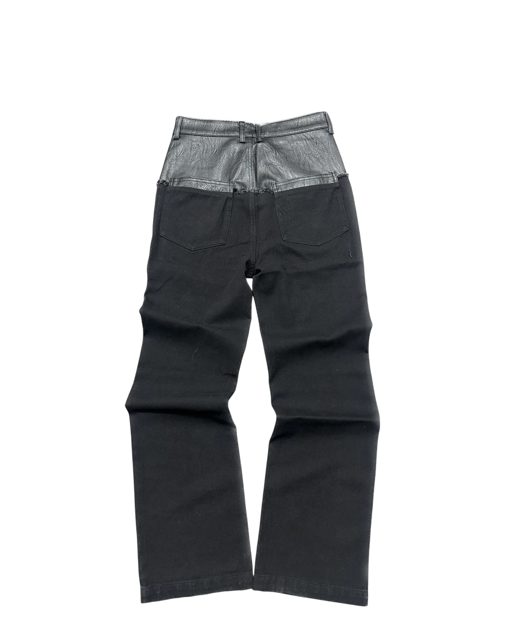 Vicious black denim jeans featuring a unique leather-look contrast waist panel and back pockets.