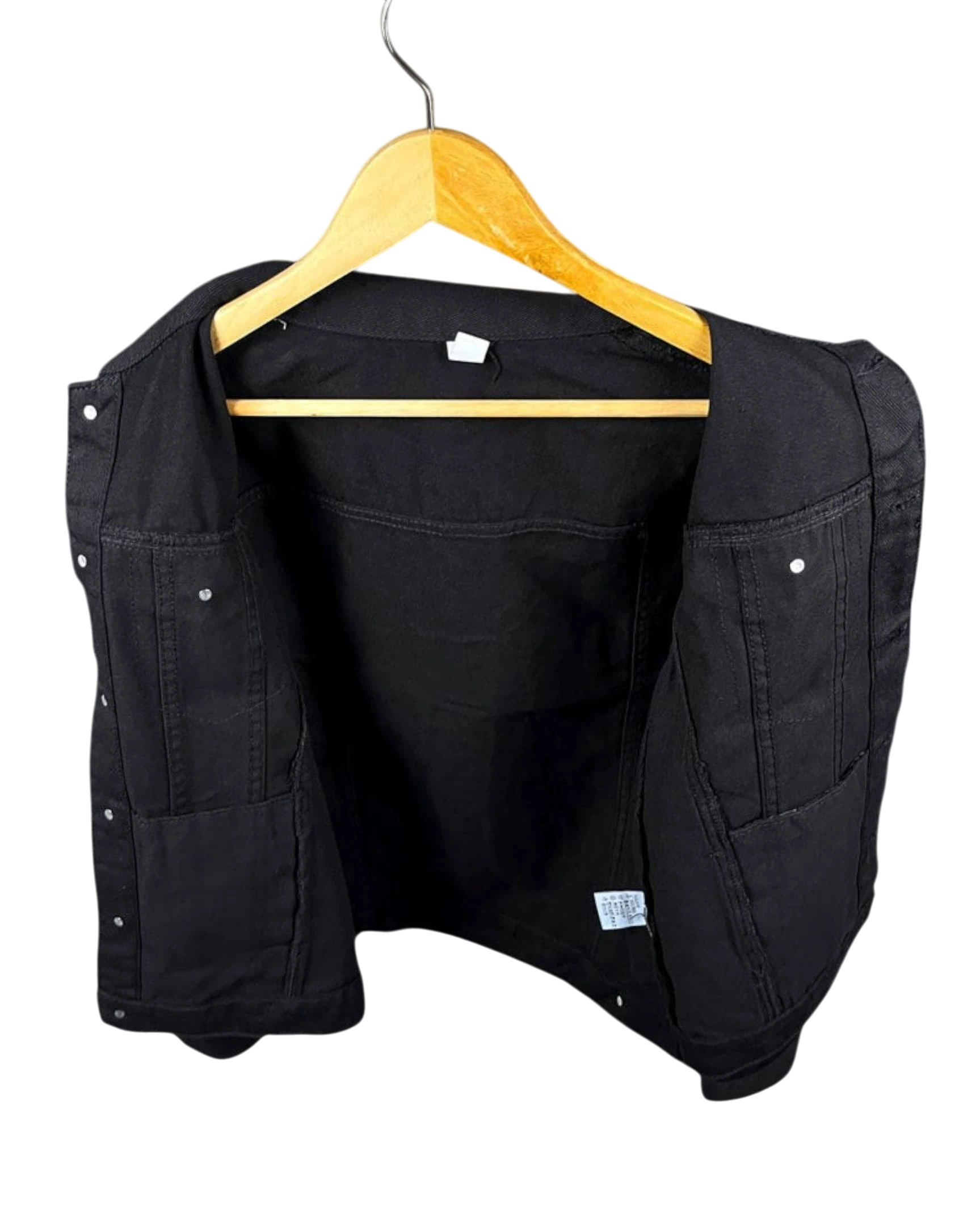 Vicious black slim fit denim jacket with distressed details, shown on a wooden hanger against a white background.