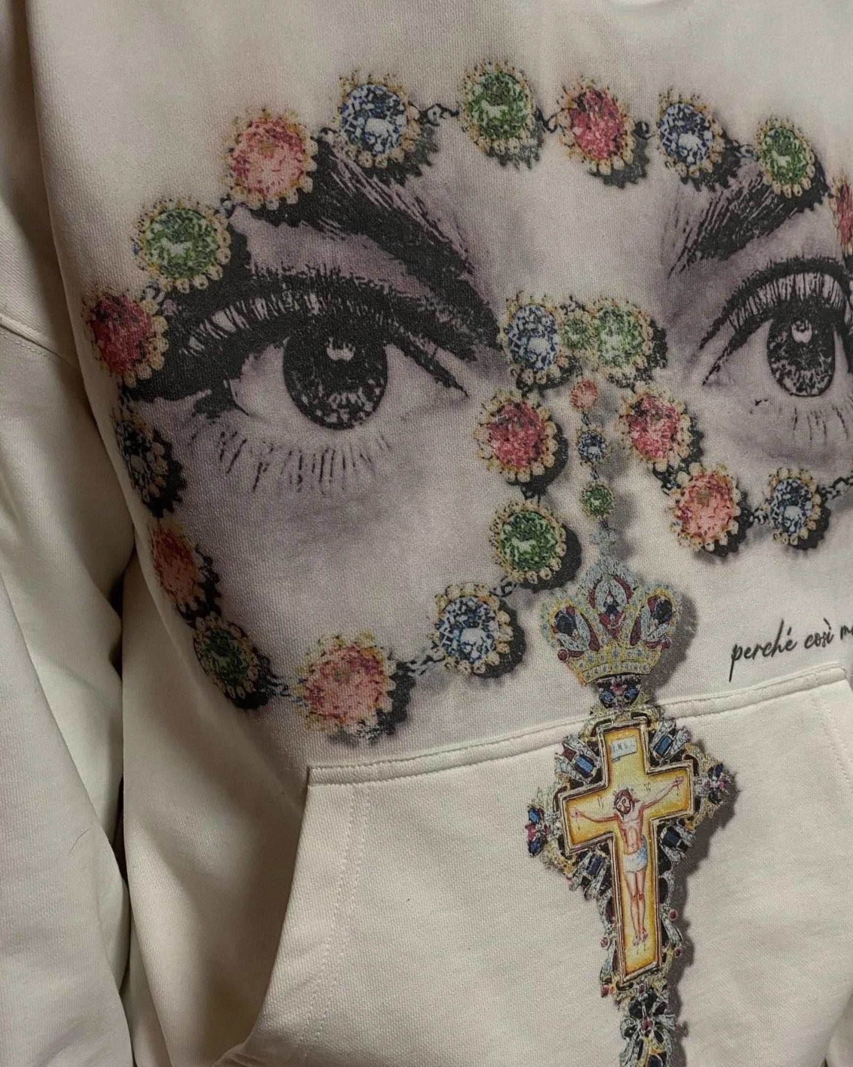 Vicious off-white hooded sweatshirt featuring a detailed graphic of eyes framed by a colorful jeweled cross rosary.