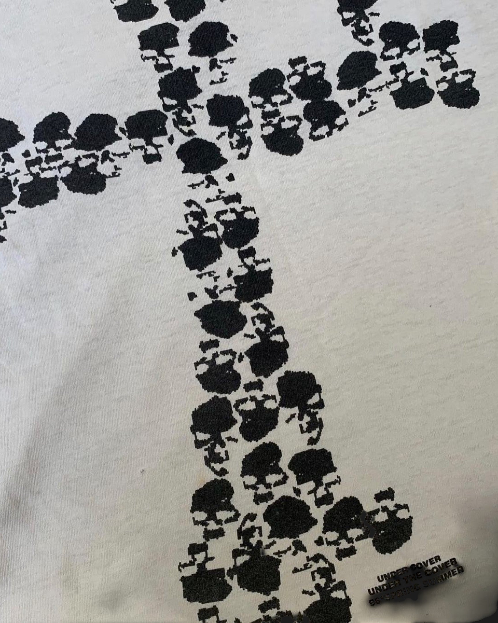 Vicious Skull Cross Tee in white cotton featuring a black graphic cross motif made of small skulls.