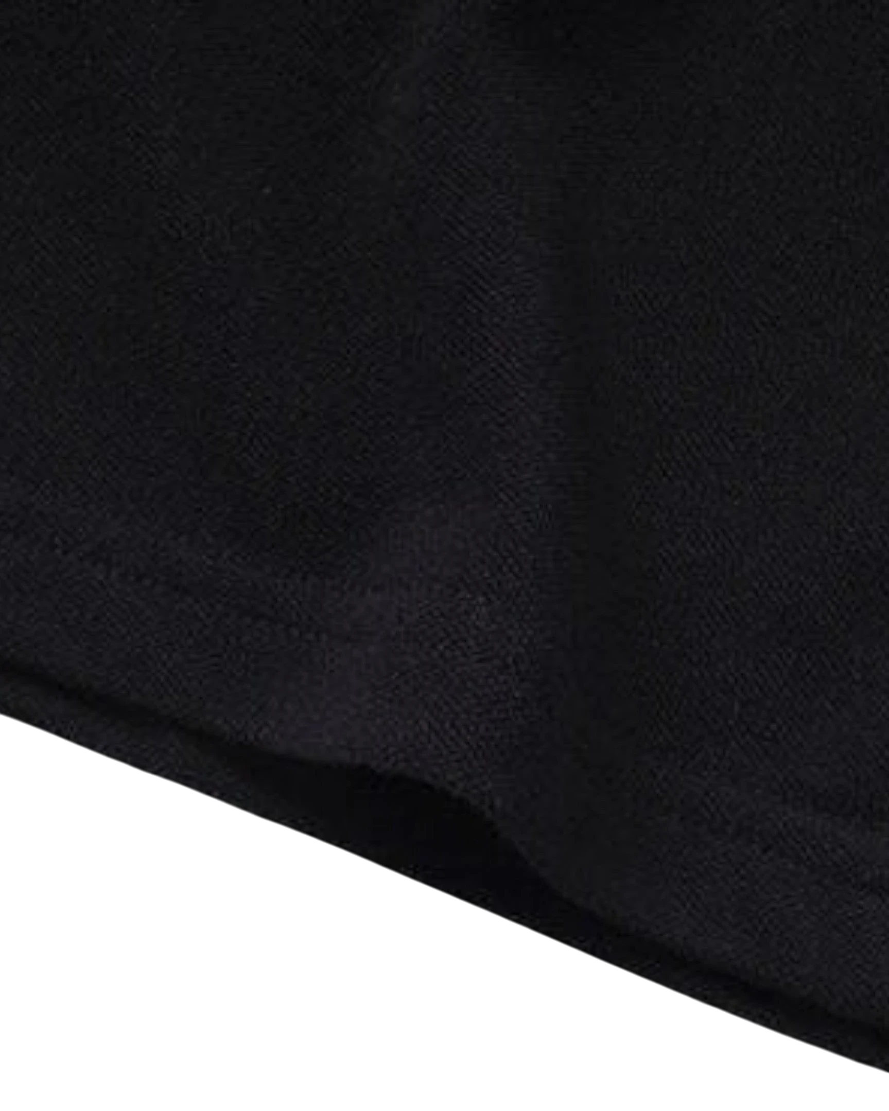 Close-up of the black cotton fabric texture of the Vicious Starlit Polo shirt.