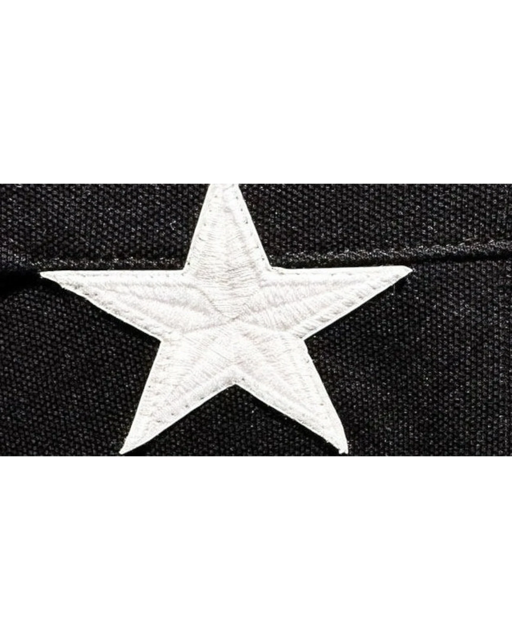 Vicious Starlit Polo featuring a detailed white embroidered star on black cotton fabric.